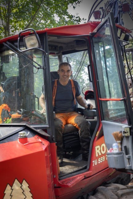 Timber harvesting operator sitting in the cab of their machine